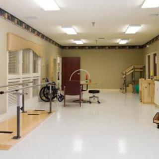 A rehabilitation room equipped with physical therapy tools and exercise equipment.