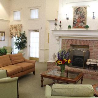 A cozy living room with a brick fireplace and comfortable seating.