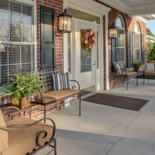 A welcoming front porch with comfortable seating and decorative elements.