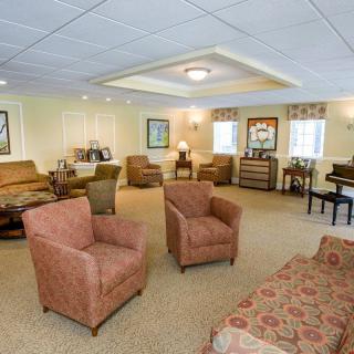 A spacious and cozy living room with various seating options and warm lighting.