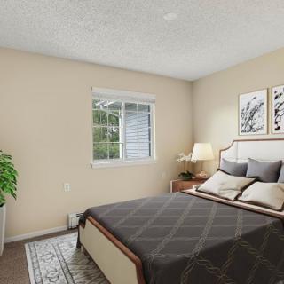 A cozy and well-decorated bedroom featuring neutral tones, modern artwork, and a touch of greenery.