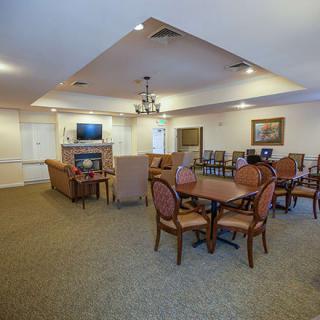 A spacious interior living room with dining area, featuring comfortable seating and a television.