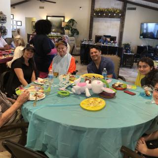 A group of people enjoying a meal together indoors around a table.