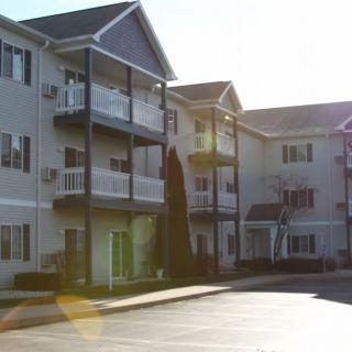 A sunlit view of a residential apartment building with balconies.