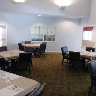 An empty dining area with tables and chairs arranged neatly.
