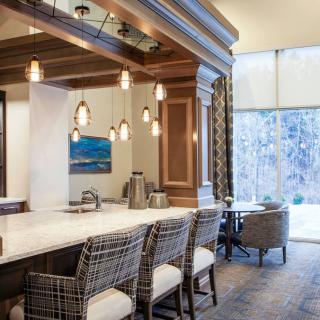 A modern luxury kitchen interior with elegant lighting and bar seating.