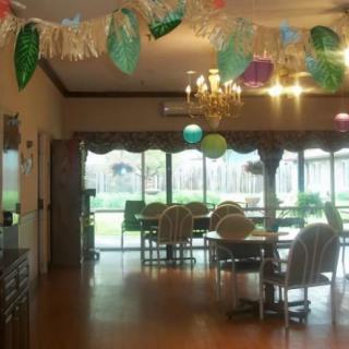 A decorated room with tables and chairs set up for a party.