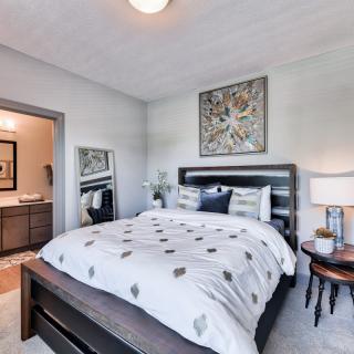 A well-decorated bedroom with modern furnishings and artwork.