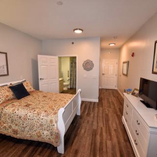 Cozy bedroom with wooden flooring and stylish decor.