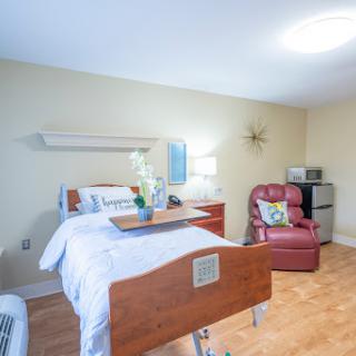 A well-lit and comfortable hospital room designed for patient care and rehabilitation.