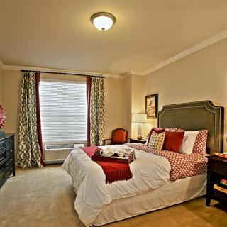 A cozy and elegantly furnished bedroom with a warm color palette.