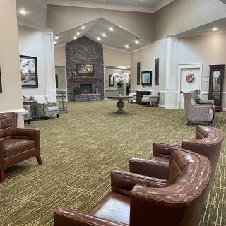 A spacious lobby with comfortable seating and a fireplace.