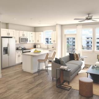 A modern open floor plan apartment with a kitchen and living room area, featuring contemporary furniture and abundant natural light.