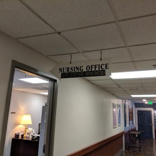 A sign indicating the location of the leasing office in a building.