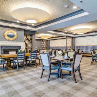 An elegantly designed dining area with neatly arranged tables and chairs.