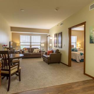 A cozy apartment featuring a living room with comfortable seating and a dining area.