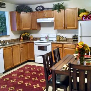 Cozy kitchen with wooden cabinets and a small dining area.