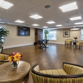 A spacious lounge area with comfortable seating and decorative plants.