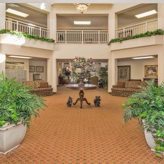 Spacious lobby with elegant decor and greenery.