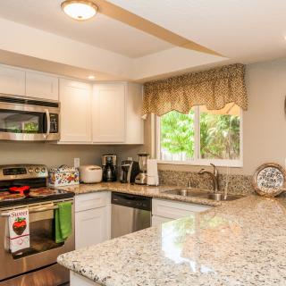 A modern kitchen featuring granite countertops and stainless steel appliances.