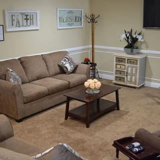 A cozy living room with a sofa, coffee table, and decorative elements.