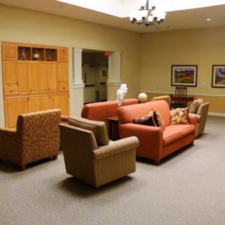 A cozy living room with comfortable seating and warm lighting.