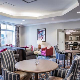 A cozy and elegantly decorated living room with comfortable seating and tasteful decor.