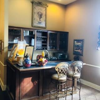 A cozy home bar setup with stools and a well-organized countertop.