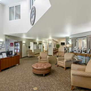 A spacious lobby area with comfortable seating and a reception desk.