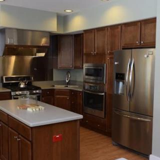 A modern kitchen featuring sleek wooden cabinets, state-of-the-art appliances, and a spacious island.