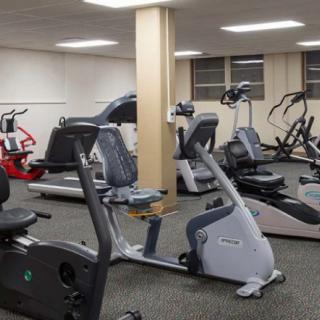 An indoor gym with various exercise equipment including stationary bikes and treadmills.
