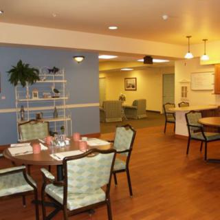 A cozy dining area with neatly set tables and comfortable seating.