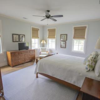 A serene and modern bedroom featuring natural light, minimalistic furniture, and a calming color palette.