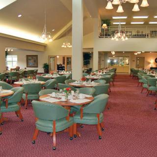 An elegant and spacious dining room with neatly arranged tables and chairs.