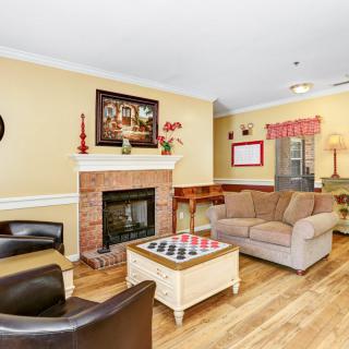 A cozy living room with a fireplace, comfortable seating, and stylish decor.