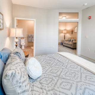A cozy bedroom with soft lighting and elegant decor, featuring a comfortable bed and modern furnishings.