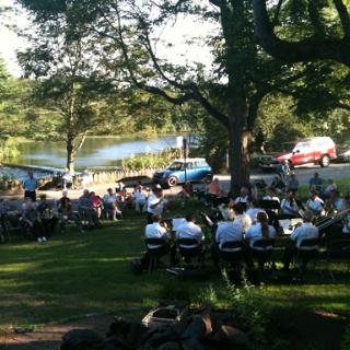 A lively outdoor gathering surrounded by nature.