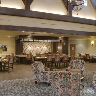 A spacious and elegantly decorated lounge with comfortable seating.