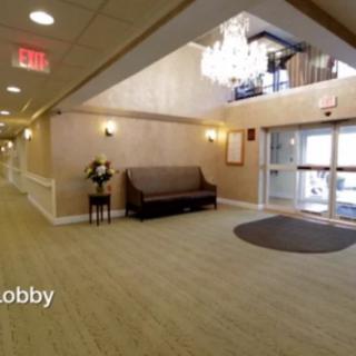 A welcoming lobby with a chandelier and seating area.