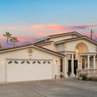 A beautiful two-story house with a sunset backdrop.