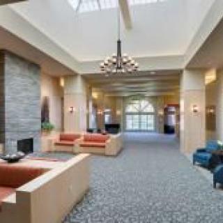 Modern lobby with cozy seating and a fireplace.