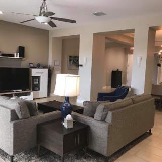 A cozy and modern living room setup featuring comfortable sofas, a stylish lamp, and a television.