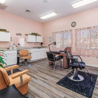 A cozy hair salon interior with styling chairs and beauty equipment.