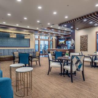 A modern lounge area featuring stylish furniture and ambient lighting.