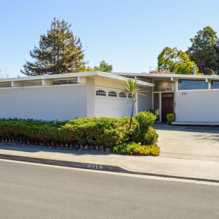 Mid-century modern house with a landscaped front yard.
