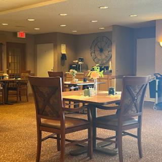 A cozy dining area featuring wooden furniture and warm lighting, perfect for casual gatherings.