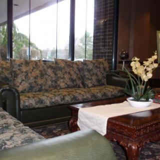 A cozy living room with floral sofas and a wooden coffee table.