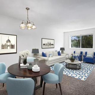 A modern living room and dining area with blue accents and contemporary furniture.