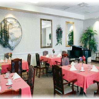 A neatly arranged restaurant dining area with tables set for service.