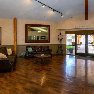 Spacious lobby area with comfortable seating and wooden flooring.
